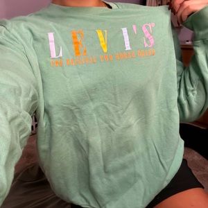 Levi crew neck with neon colored lettering on the front.